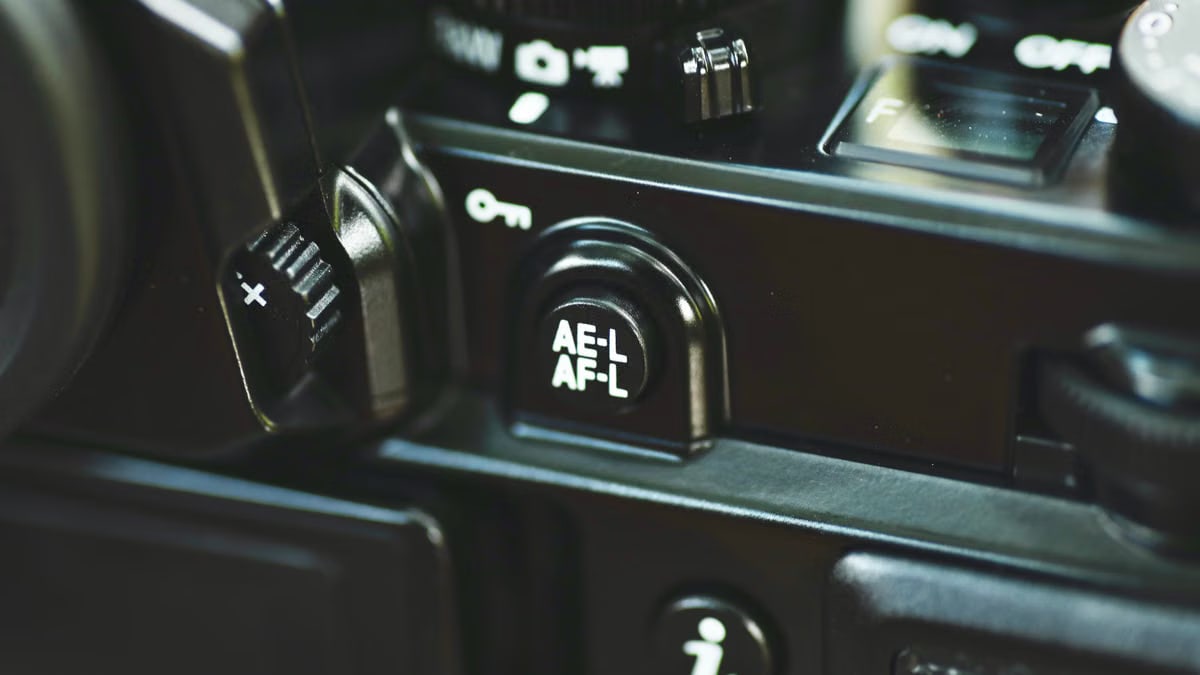 Detailed view of a camera's AE-L AF-L button, showcasing intricate design and structure.
